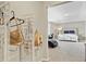 Walk-in closet featuring metal racking, hanging clothing and purses, and a peek into the spacious bedroom at 1727 Wood Violet Dr, Orlando, FL 32824