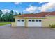 Two-car garage with arched windows and a paved driveway at 19115 Palmview St, Orlando, FL 32833