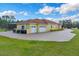 Three car garage with a long driveway and beautiful landscaping at 19115 Palmview St, Orlando, FL 32833