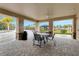 Covered patio area with table and chairs near the community pool at 2480 Penguin Blvd, Davenport, FL 33837