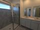 Bathroom with double vanity, large shower, and grey tile at 2499 Skyline Loop, Kissimmee, FL 34758