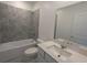 Bathroom with tub, single vanity, and grey tile at 2499 Skyline Loop, Kissimmee, FL 34758