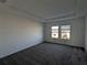 Spacious bedroom with grey carpet and two large windows at 2499 Skyline Loop, Kissimmee, FL 34758