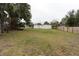 Large backyard with grassy area and wooden fence at 25335 Troon Ave, Sorrento, FL 32776