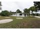 White single story home with grassy yard at 25335 Troon Ave, Sorrento, FL 32776