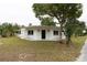 Modern exterior with white brick and a well-maintained lawn at 25335 Troon Ave, Sorrento, FL 32776