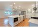 Bright kitchen features a large island, stainless steel appliances, and white cabinetry at 25335 Troon Ave, Sorrento, FL 32776