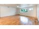 Bright living room with hardwood floors, a ceiling fan, and a window at 25335 Troon Ave, Sorrento, FL 32776