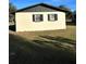 Rear view of a ranch house, white with black trim at 2863 County Road 238 # 238, Wildwood, FL 34785