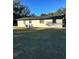 Rear view of a ranch house, white with black trim at 2863 County Road 238 # 238, Wildwood, FL 34785