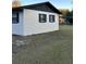 Rear view of a ranch house, white with black trim at 2863 County Road 238 # 238, Wildwood, FL 34785