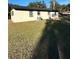 Rear view of a single story house with a large yard at 2863 County Road 238 # 238, Wildwood, FL 34785