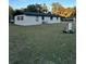 Rear view of a ranch house, white with black trim at 2863 County Road 238 # 238, Wildwood, FL 34785