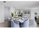 Modern dining room with grey chairs, white table and an open concept floor plan at 3582 Fort Mellon Ln, Sanford, FL 32773