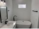 Bathroom featuring a freestanding soaking tub and modern vanity at 3901 Sw 161St Loop, Ocala, FL 34473