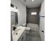 Modern bathroom with grey tile and white vanity at 3901 Sw 161St Loop, Ocala, FL 34473