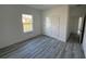 Spacious bedroom with a large window and grey flooring at 3901 Sw 161St Loop, Ocala, FL 34473