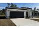 New construction home with gray garage door and stone accents at 3901 Sw 161St Loop, Ocala, FL 34473