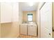 Laundry room featuring washer, dryer, and overhead shelving at 3934 Ne 21St Ln, Ocala, FL 34470