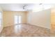 Living room with tile floors and sliding glass doors at 3934 Ne 21St Ln, Ocala, FL 34470