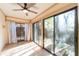 Bright sunroom with sliding glass doors leading to a private patio at 3934 Ne 21St Ln, Ocala, FL 34470