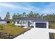 Modern two-story home with white exterior, black accents, and a three-car garage at 39715 Royal Trails Road, Eustis, FL 32736