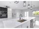 Open concept kitchen with white cabinets, marble island, and black accents at 39715 Royal Trails Road, Eustis, FL 32736