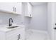 Modern laundry room with white cabinets and quartz countertop at 39715 Royal Trails Road, Eustis, FL 32736