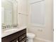 Small bathroom with granite countertop and dark brown vanity at 4021 Lana Ave, Davenport, FL 33897