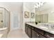 Double vanity bathroom with granite countertops and a large shower at 4021 Lana Ave, Davenport, FL 33897