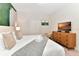 King-size bed, green wall, and TV in this relaxing bedroom at 4021 Lana Ave, Davenport, FL 33897