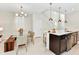 Open dining area with a glass-top table and modern chandelier at 4021 Lana Ave, Davenport, FL 33897