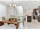 Bright dining room features a glass table, wooden bench, and modern chandelier at 4021 Lana Ave, Davenport, FL 33897