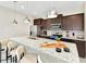 Modern kitchen island with seating and stainless steel appliances at 4021 Lana Ave, Davenport, FL 33897