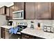 Kitchen with dark brown cabinets, granite countertops and stainless steel appliances at 4021 Lana Ave, Davenport, FL 33897