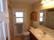 Full bathroom featuring vanity, toilet, shower/tub combo, and exterior access to a fenced yard at 4131 Yorketowne Rd, Orlando, FL 32812