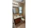 Cozy bathroom featuring a vanity with a light wood cabinet and a framed mirror at 4131 Yorketowne Rd, Orlando, FL 32812