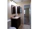 Bathroom with a dark wood vanity and medicine cabinet; neutral walls and flooring at 4131 Yorketowne Rd, Orlando, FL 32812