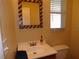 Powder room features a patriotic mirror, window and vanity with a toilet at 4131 Yorketowne Rd, Orlando, FL 32812