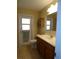 Bathroom featuring a wood vanity, mirror, and a door to the outside at 4131 Yorketowne Rd, Orlando, FL 32812