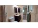 Well-lit bathroom featuring a walk-in shower with tiled walls at 4131 Yorketowne Rd, Orlando, FL 32812