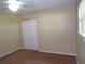 Neutral bedroom featuring carpet, cream colored walls, ceiling fan, and shutter style closet doors at 4131 Yorketowne Rd, Orlando, FL 32812
