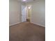 Neutral bedroom with carpet flooring and an open doorway to another room at 4131 Yorketowne Rd, Orlando, FL 32812