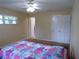 Comfortable bedroom with natural light, a vibrant quilt, and ample closet space at 4131 Yorketowne Rd, Orlando, FL 32812