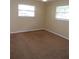 Bedroom with two windows and tan carpet at 4131 Yorketowne Rd, Orlando, FL 32812