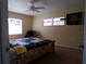 Comfortable bedroom with ceiling fan, large windows, and carpeting at 4131 Yorketowne Rd, Orlando, FL 32812