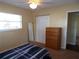 Bedroom with carpet, a window, closet, dresser and full length mirror at 4131 Yorketowne Rd, Orlando, FL 32812