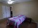 Inviting bedroom featuring a colorful quilt, neutral walls, and easy access to other rooms at 4131 Yorketowne Rd, Orlando, FL 32812
