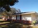 Ranch house with red shutters and brick foundation at 4131 Yorketowne Rd, Orlando, FL 32812