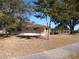 Ranch house with attached garage and large tree at 4131 Yorketowne Rd, Orlando, FL 32812